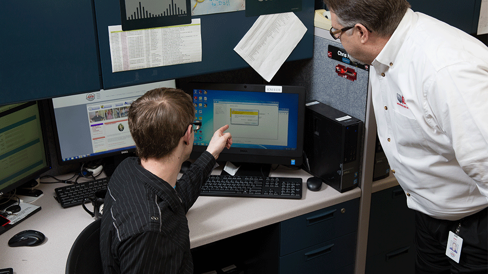 Permit coordinator explaining restrictions to colleague